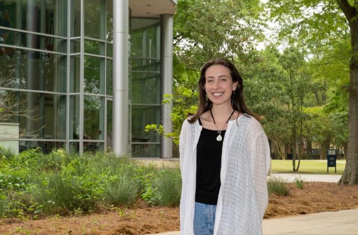 Photo of a female student standing on ODU’s campus. 